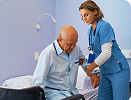 Caregiver supporting senior woman at home