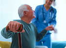 Nurse assisting elderly man with mobility